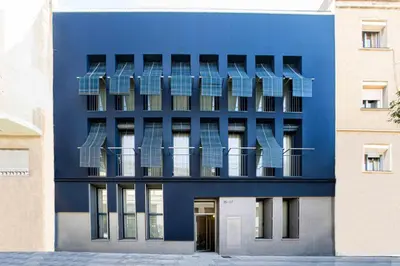 a blue building with balconies on the side of it at Barcelona Touch Apartments - Rosich in Hospitalet de Llobregat