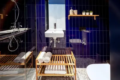 a bathroom with blue tiled walls and a sink at Barcelona Touch Apartments - Rosich in Hospitalet de Llobregat