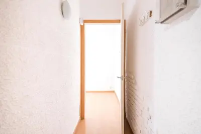 an open door in a room with a white wall at Homenfun Barcelona Gracia in Barcelona