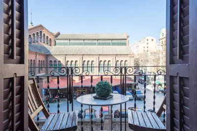 a balcony with a table and chairs and a building at Mirall Sant Gervasi in Barcelona