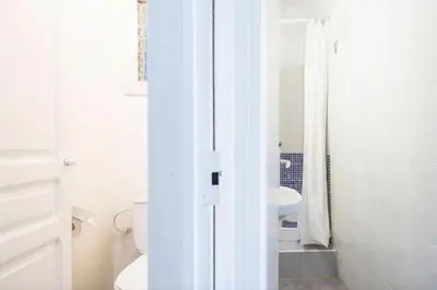a white bathroom with a toilet and a sink at Mirall Sant Gervasi in Barcelona