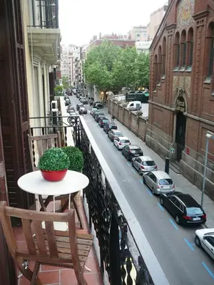 a balcony with a table and a view of a street at Mirall Sant Gervasi in Barcelona