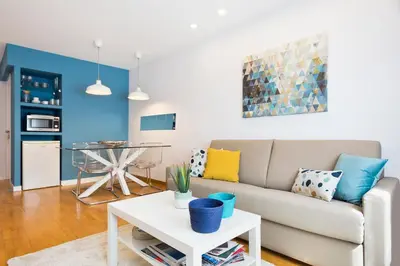 a living room with a couch and a table at Apartamento Rambla Catalunya in Barcelona