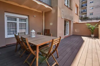 a wooden deck with a table and chairs on a balcony at BBarcelona Sagrada Familia Flats in Barcelona