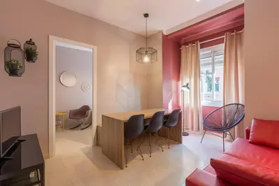 a kitchen and living room with a table and chairs at ApartEasy - Plaza España & Fira in Barcelona