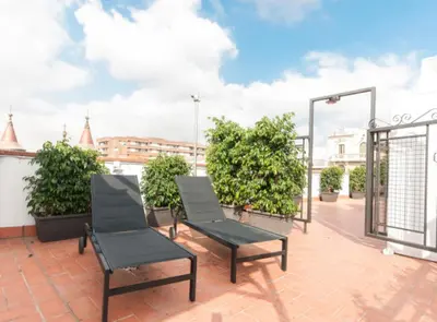 a patio with two chairs on a roof at Picasso Suites in Barcelona