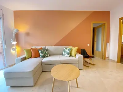 a living room with a couch and a table at Terracotta terrace in Barcelona