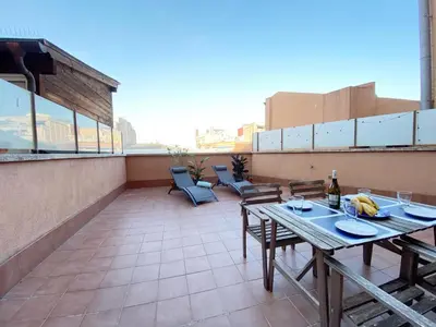 a patio with a table and chairs on a roof at Terracotta terrace in Barcelona
