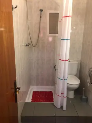 a bathroom with a shower with a toilet and a shower curtain at Pensión Galicia in Canovellas
