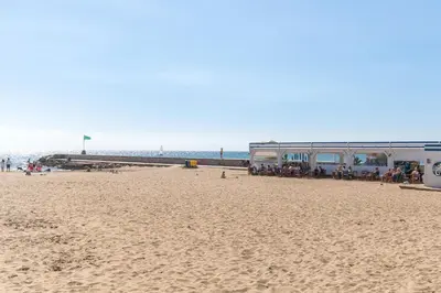 a beach with a bus parked on the sand at Fragata Sitges Rentals in Sitges