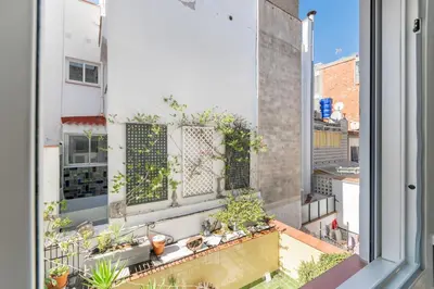 a view from an open window of a balcony with plants at Fragata Sitges Rentals in Sitges