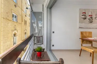 a balcony with a table and a plant at Fragata Sitges Rentals in Sitges