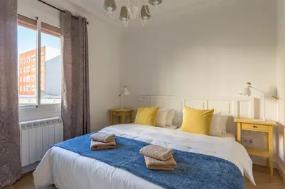 a bedroom with a large white bed with yellow pillows at Moreryadom in Barcelona