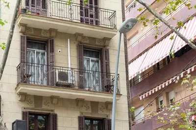 a building with two balconies and a street light at Stay U-nique Apartments Lope de Vega in Barcelona
