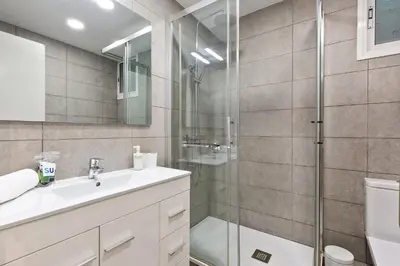 a bathroom with a sink and a glass shower at Stay U-nique Apartments Lope de Vega in Barcelona