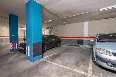 a parking garage with two cars parked in it at Stay U-nique Apartments Diagonal II in Barcelona