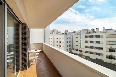 a balcony with a table and chairs on a building at Stay U-nique Apartments Diagonal II in Barcelona