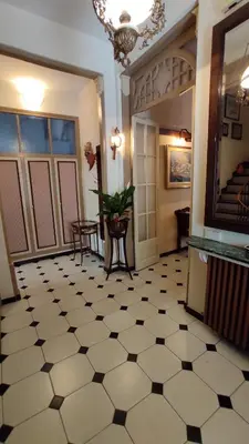 a hallway with a black and white tiled floor at Casa MO in Sabadell