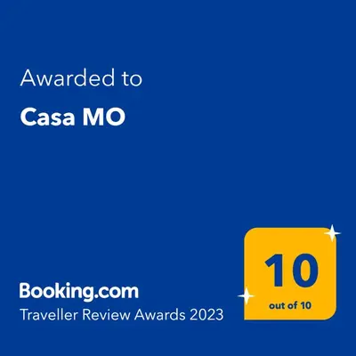 a yellow sign with the text awarded to casa mozer review awards at Casa MO in Sabadell