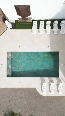 a group of white chairs and a swimming pool at Lidia's Rural House (HUTB-0615) in Barcelona