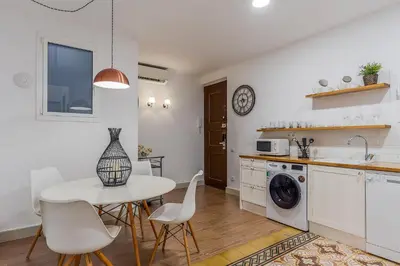 a kitchen and dining room with a table and chairs at AB Eixample Calabria in Barcelona
