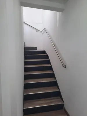 a staircase in a building with a stair railing at Apartaco Apartamentos in Sitges