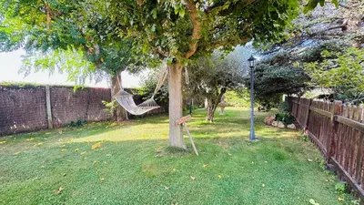 a hammock hanging from a tree in a yard at Apartment with private pool and garden in San Martín Sarroca