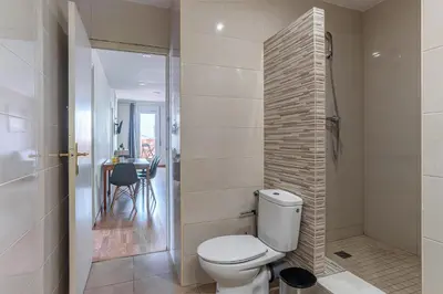 a bathroom with a toilet and a walk in shower at AB Sagrada Familia Views in Barcelona