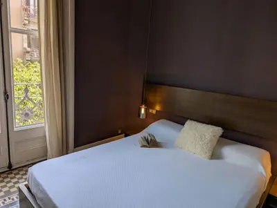 a bedroom with a white bed and a window at Period Luxury Apartment in Barcelona Prime Location with Street View in Barcelona