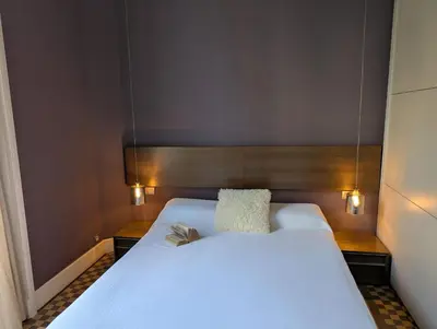 a large white bed with two pillows on it at Period Luxury Apartment in Barcelona Prime Location with Street View in Barcelona
