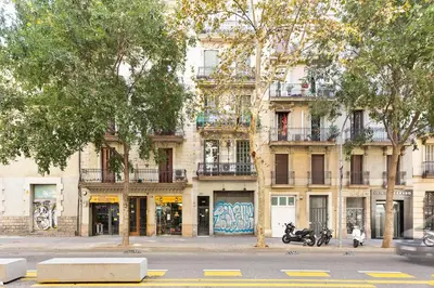 a building with motorcycles parked in front of it at Stay U-nique Apartments Consell in Barcelona