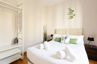 a white bedroom with a large white bed with white pillows at Stay U-nique Apartments Consell in Barcelona