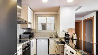 a kitchen with white cabinets and a counter top at HOSTAL BEDMATES in Barcelona