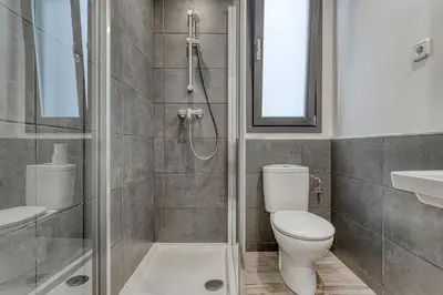 a bathroom with a shower and a toilet and a sink at HOSTAL BEDMATES in Barcelona