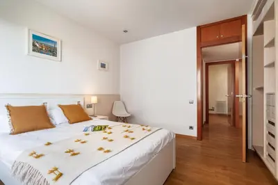 a bedroom with a large white bed with yellow pillows at Flateli Paris in Barcelona