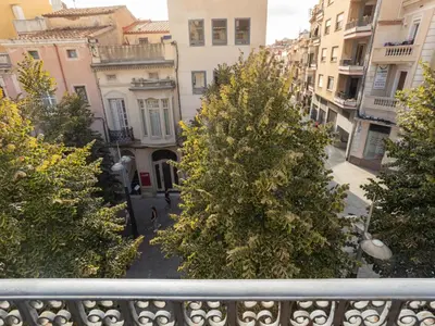 a view from the balcony of a building with trees at Matarolux23 in Mataró