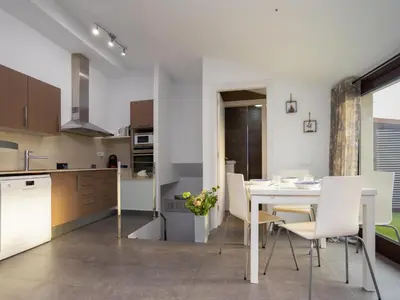 a kitchen and dining room with a table and chairs at Matarolux23 in Mataró