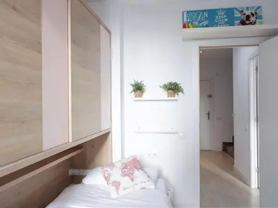 a room with a bed and two plants on the wall at Matarolux23 in Mataró