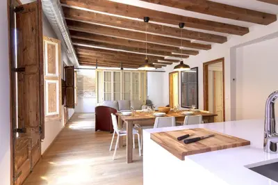a kitchen and dining room with a wooden ceiling at Bellafila Gothic Terrace in Barcelona