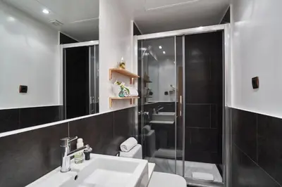 a bathroom with a shower and a sink and a toilet at Cathedral Apartments in Barcelona
