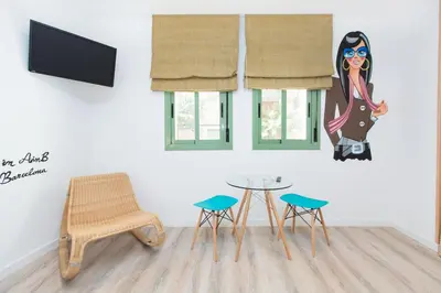 a room with a table and chairs and a tv at Cathedral Apartments in Barcelona