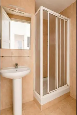 a bathroom with a sink and a glass shower at BELLAFILA GOTHIC in Barcelona