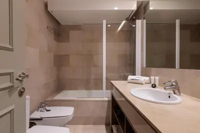 a bathroom with a toilet and a sink and a tub at Passeig de Gràcia by Enjoybcn in Barcelona