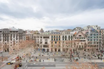 a view of a city street with buildings at Passeig de Gràcia by Enjoybcn in Barcelona