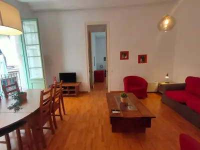 a living room with a red couch and a table at Esparteria 1 in Barcelona