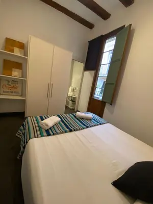 a bedroom with two beds and a window at Esparteria 2 in Barcelona