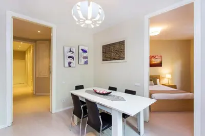 a white dining room with a table and chairs at Stay U-nique Apartments Floridablanca II in Barcelona