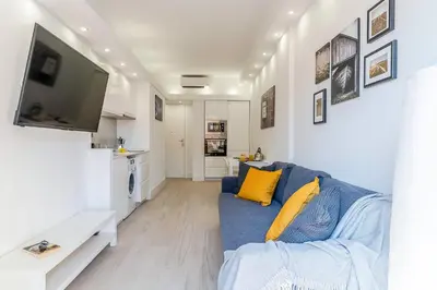 a living room with a blue couch and a tv at 236 - AB Poble Sec Montjuic in Barcelona