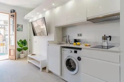 a white kitchen with a washing machine in it at 236 - AB Poble Sec Montjuic in Barcelona