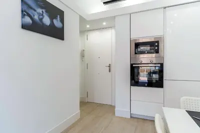 a white kitchen with a stove and a microwave at 236 - AB Poble Sec Montjuic in Barcelona